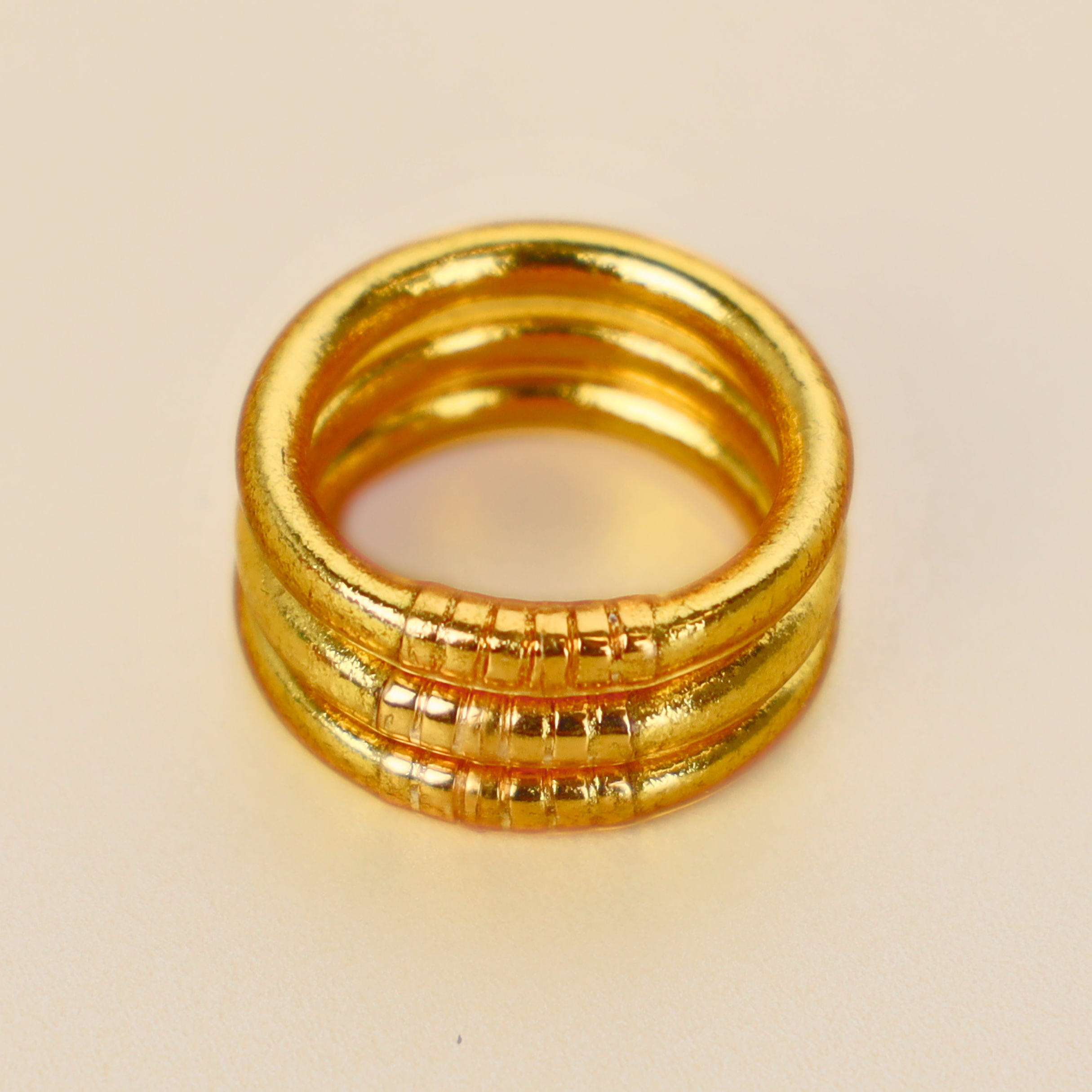 a gold ring on a white surface