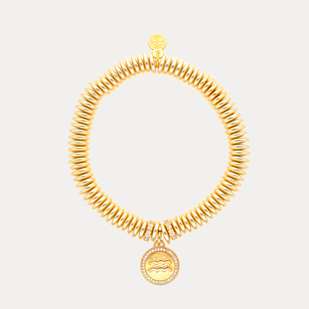 Gold necklace with a pendant on a light gray background