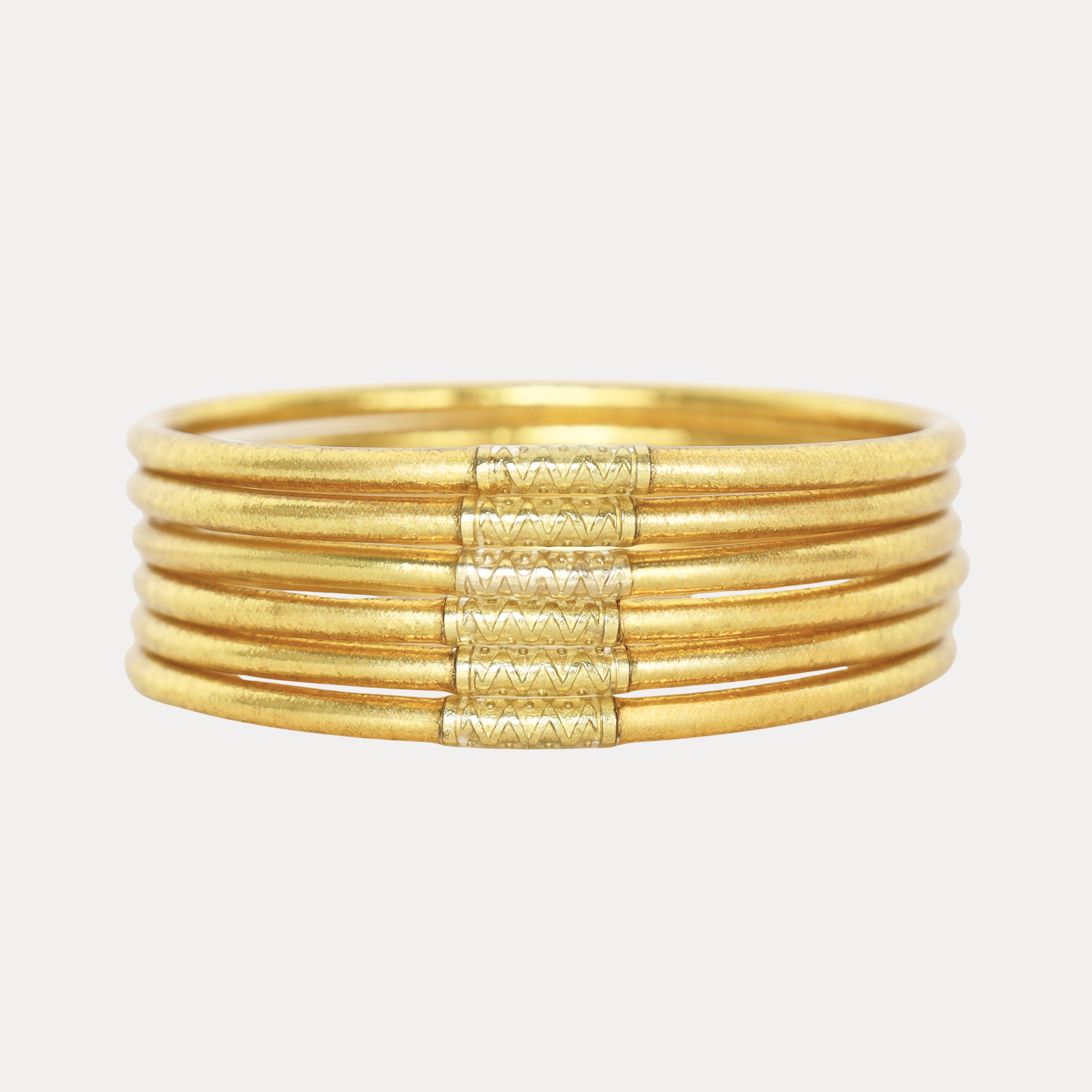 a gold bracelet with a few stripes