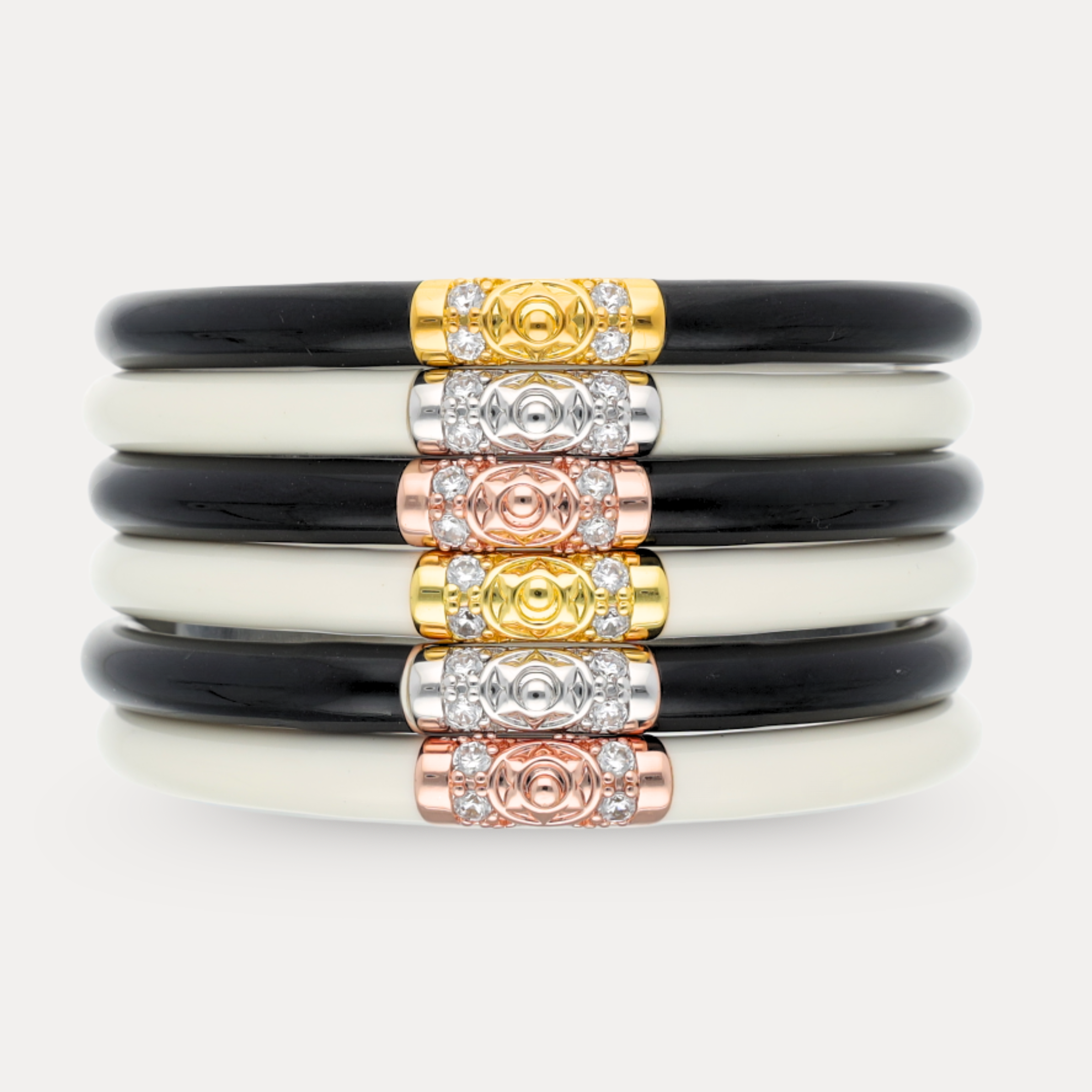 a stack of black and white bracelets