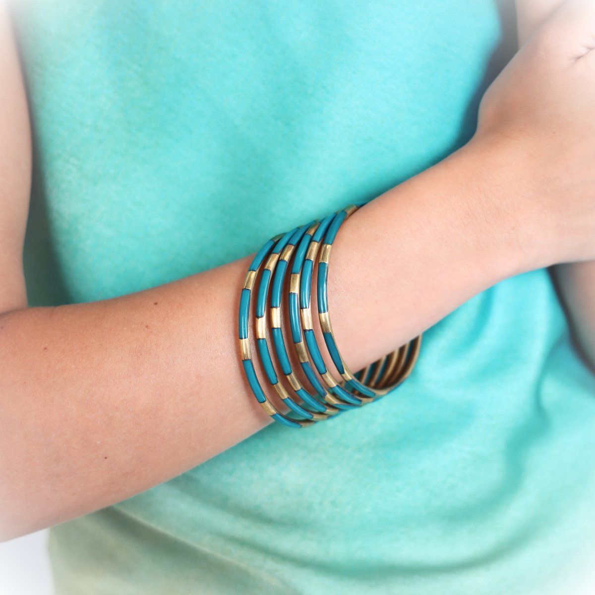 a person wearing bracelets on their wrist