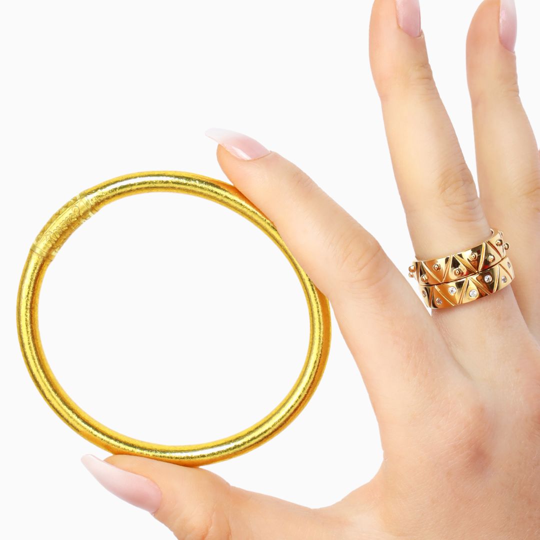 Model Wearing 22kt Gold Plated Serenity Rings While Holding a Single Gold All Weather Bangle Bracelet | BuDhaGirl