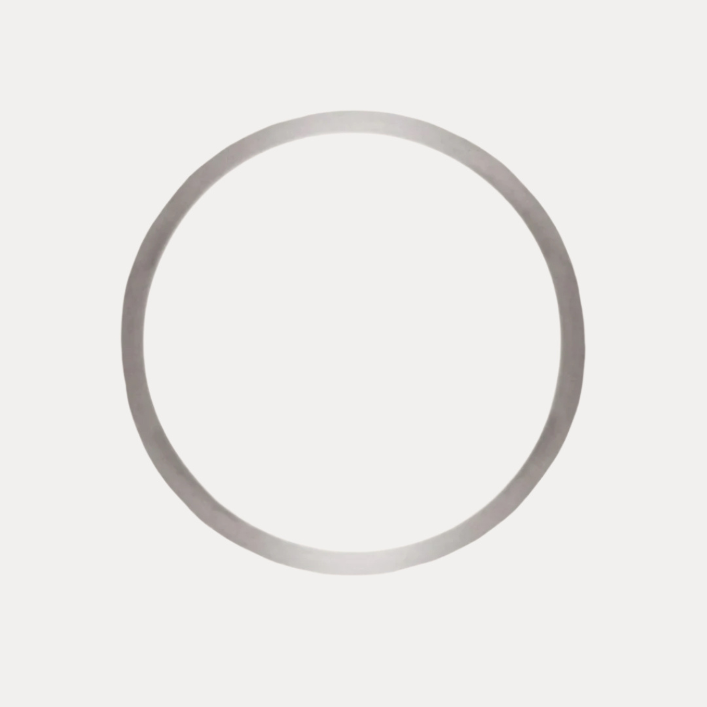a circular silver ring on a white background