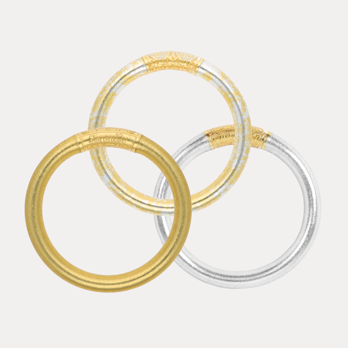 BuDhaGirl trio of metallic bangle bracelets for women in gold silver and translucent tones with embossed detailing arranged in an overlapping circular design