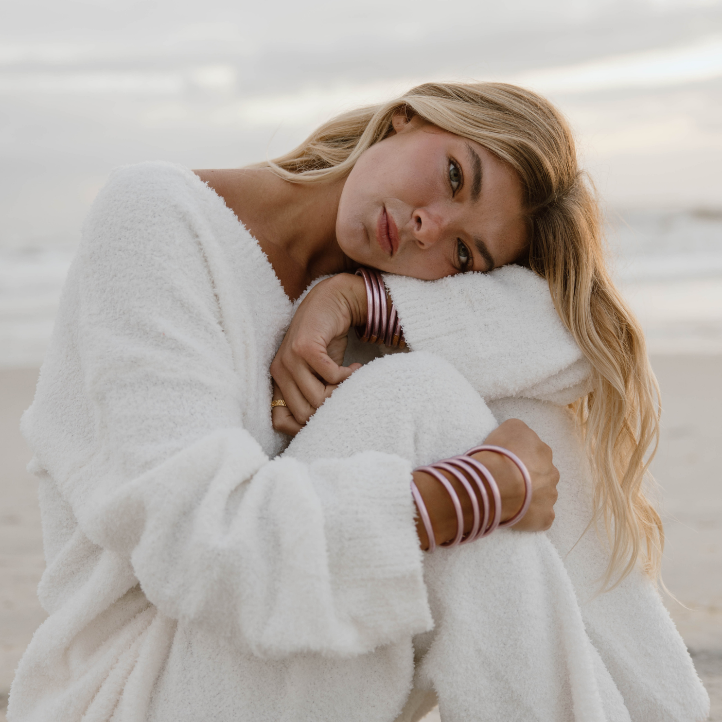 a woman sitting on a beach