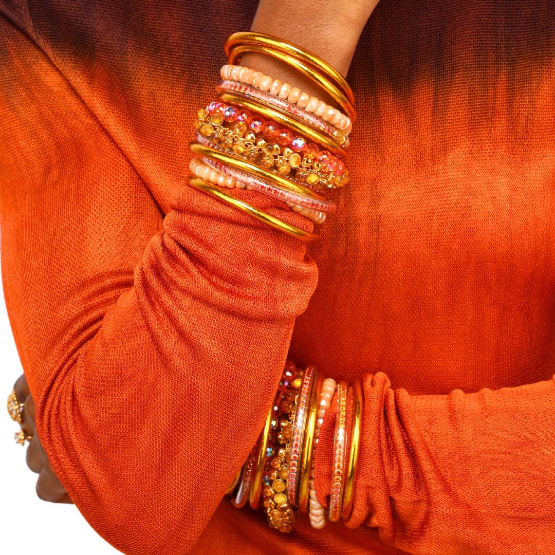 Orange Spark Collection Bracelets on Model Wearing Orange Sunset Ombre Dress | BuDhaGirl
