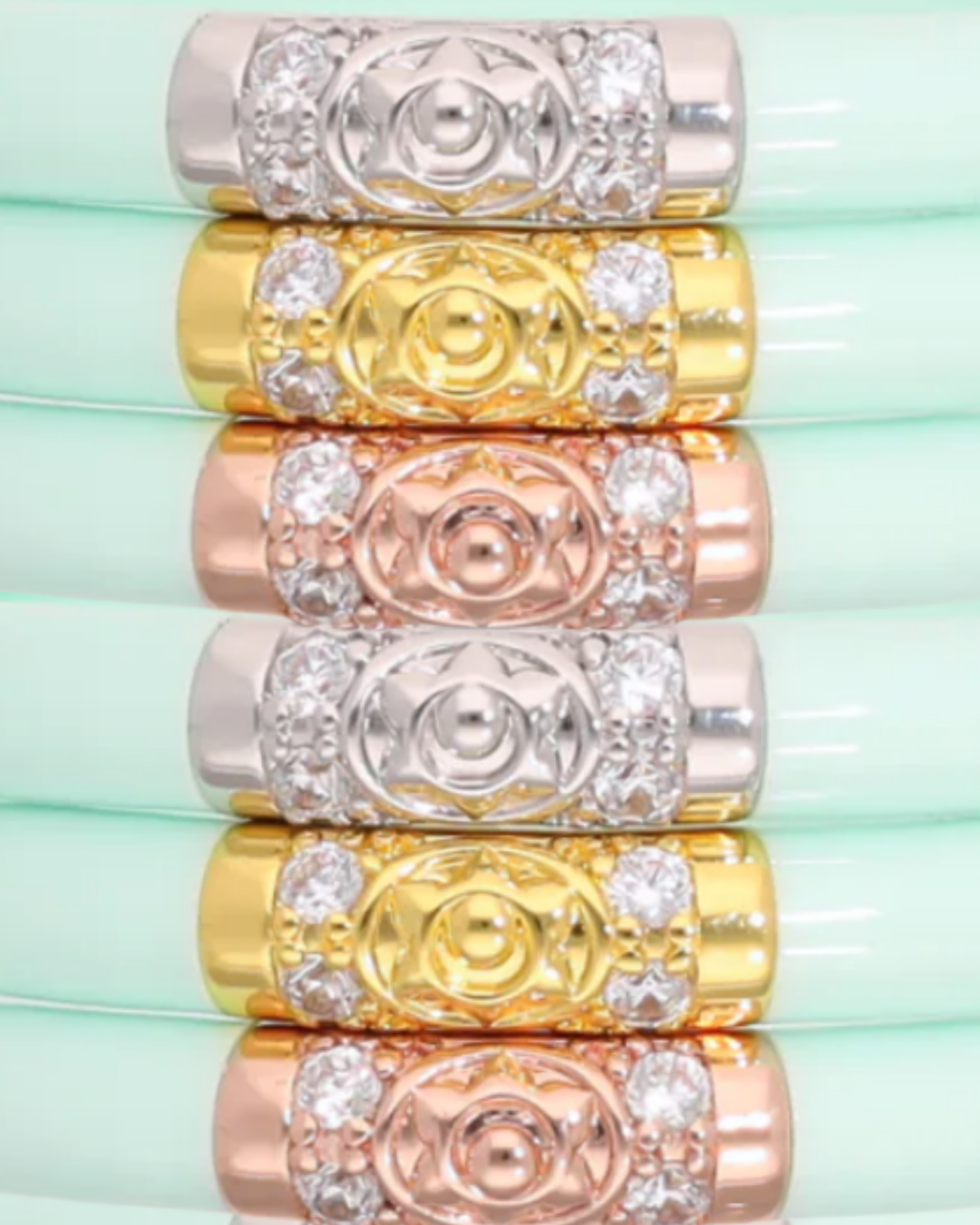 a stack of rings with gold and silver