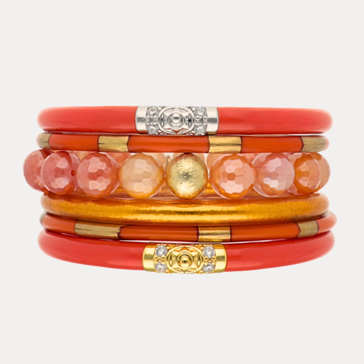 a stack of orange and gold bracelets