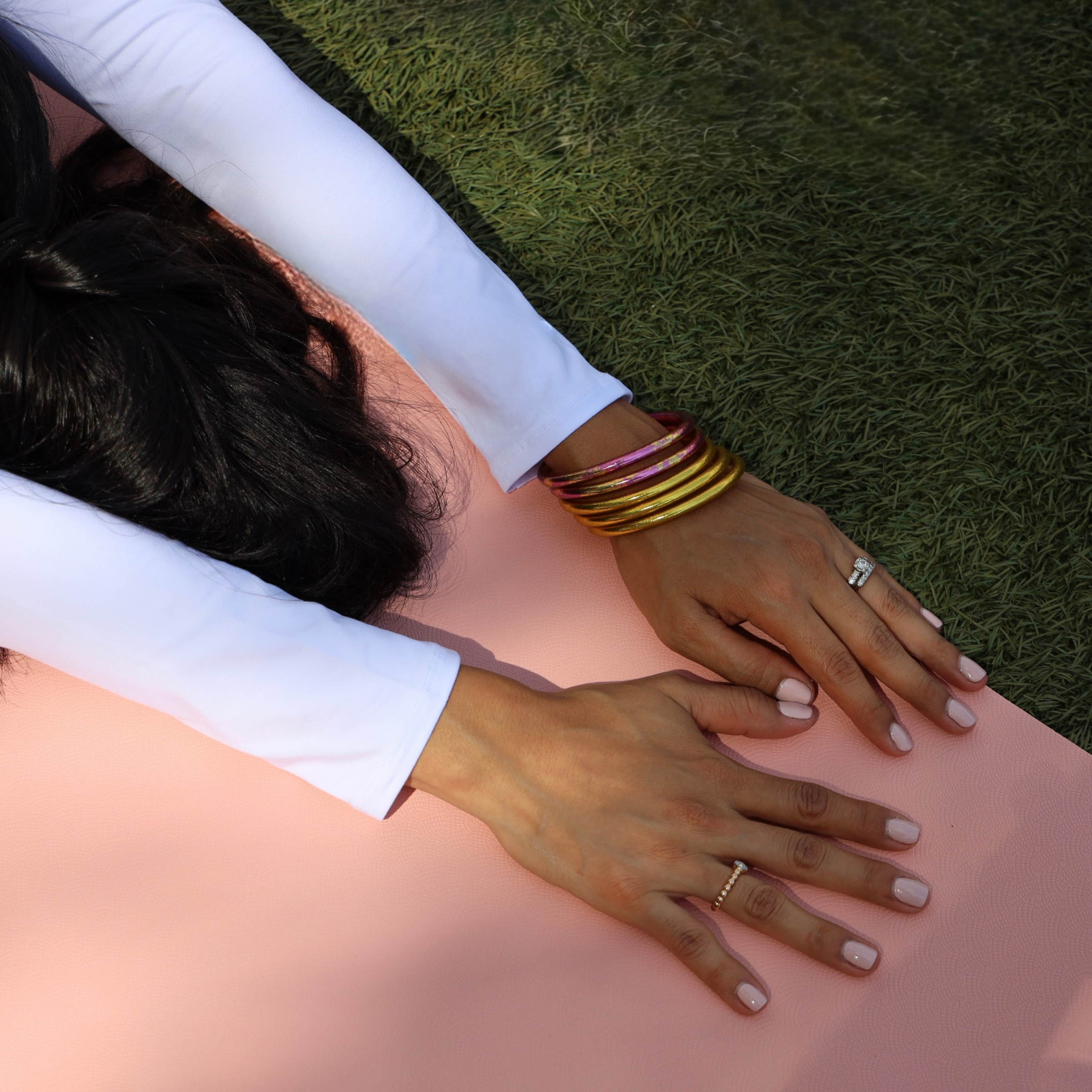 a person lying on a mat with their hands on their sides