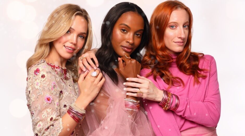Three women wearing BuDhaGirl's Carousel Pink Collection Nebula Rings, All Weather Bangles® In Carousel Pink, Meghan Bracelet in clear, Meghan bracelet in Pink, Clear Etoile Bracelet, and Dahlia Bracelet in Peony | BuDhaBrief by BuDhaGirl 