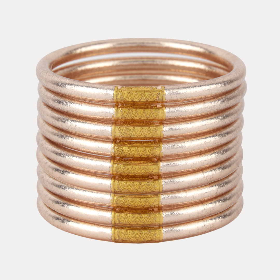 Stack of champagne gold gold accents on a white background