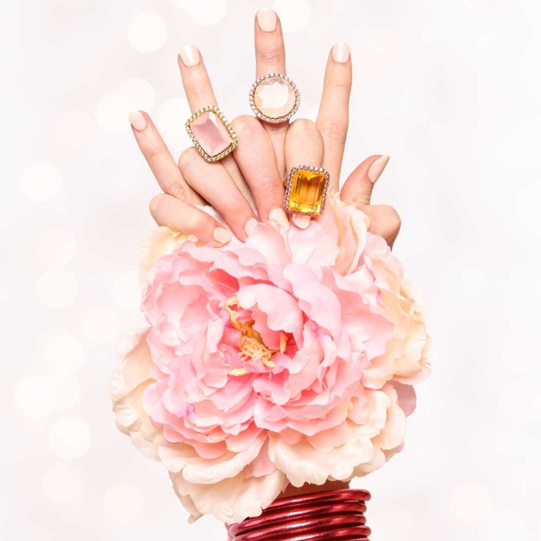 Model's hands wearing Nebula Rings and Carousel Pink All Weather Bangles | BuDhaGirl