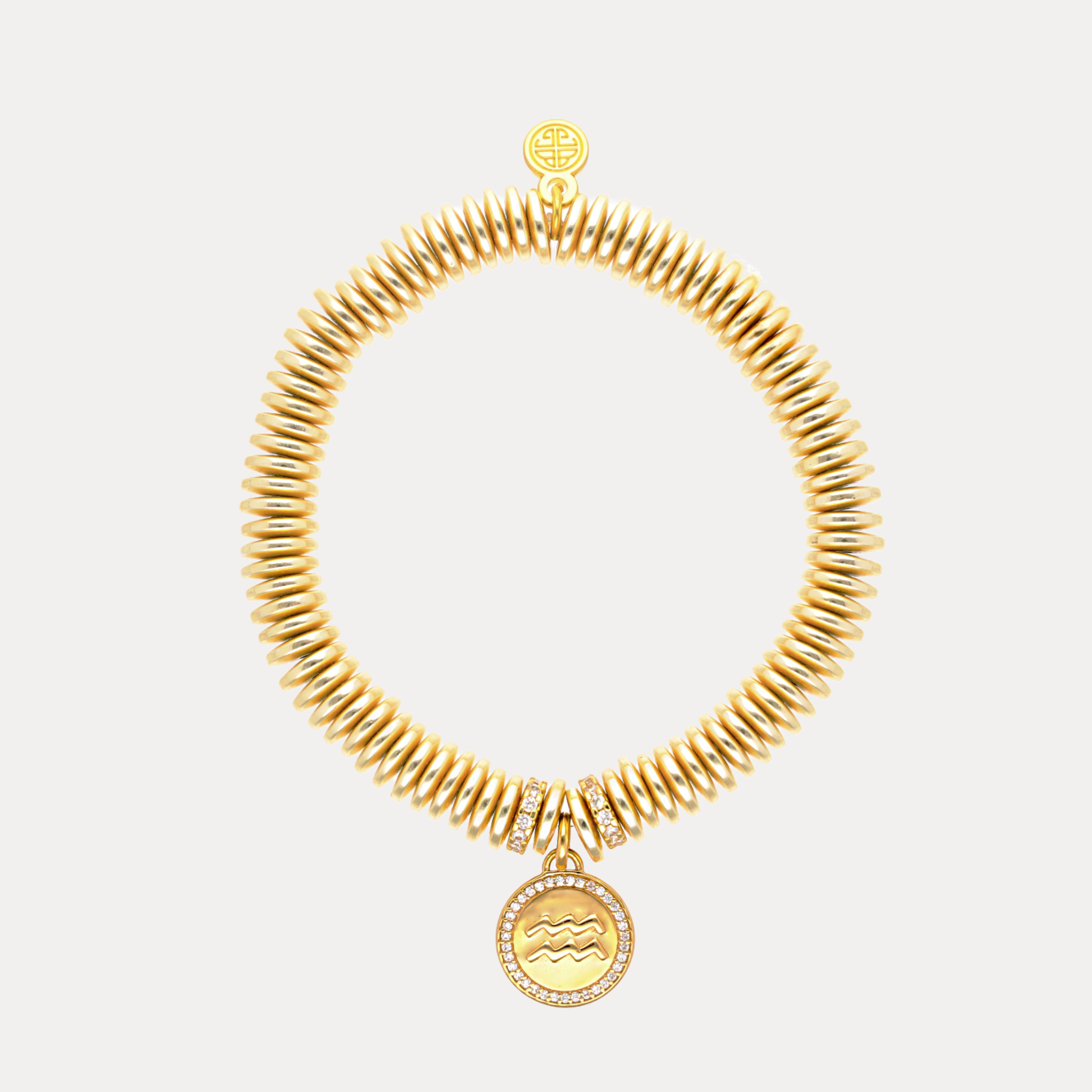 Gold necklace with a pendant on a light gray background