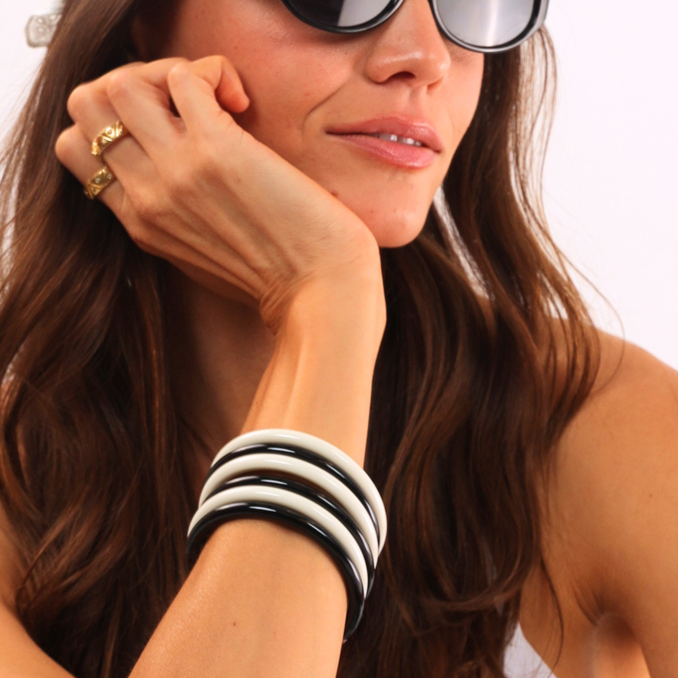 a woman wearing sunglasses and a bracelet