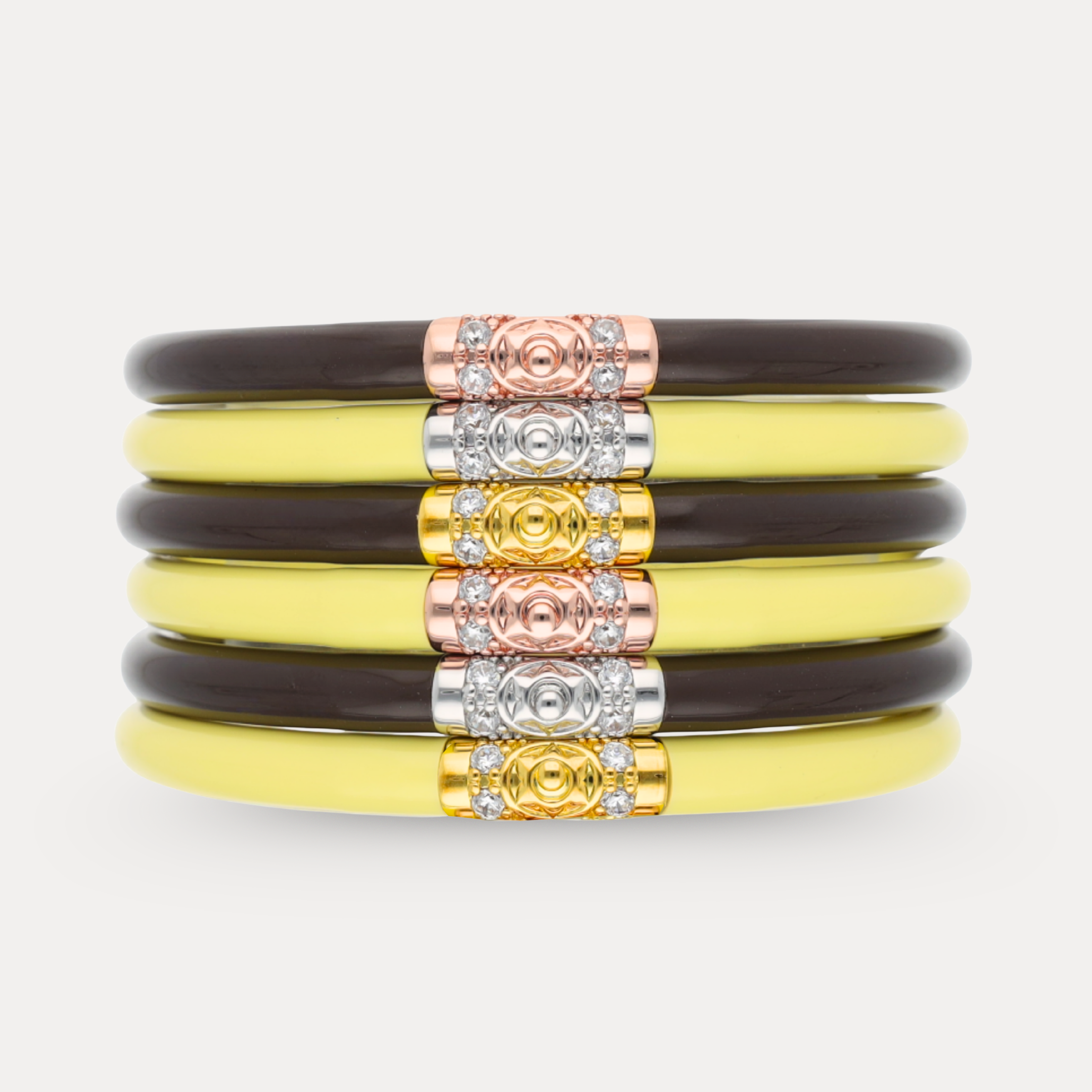 a stack of yellow and silver bracelets