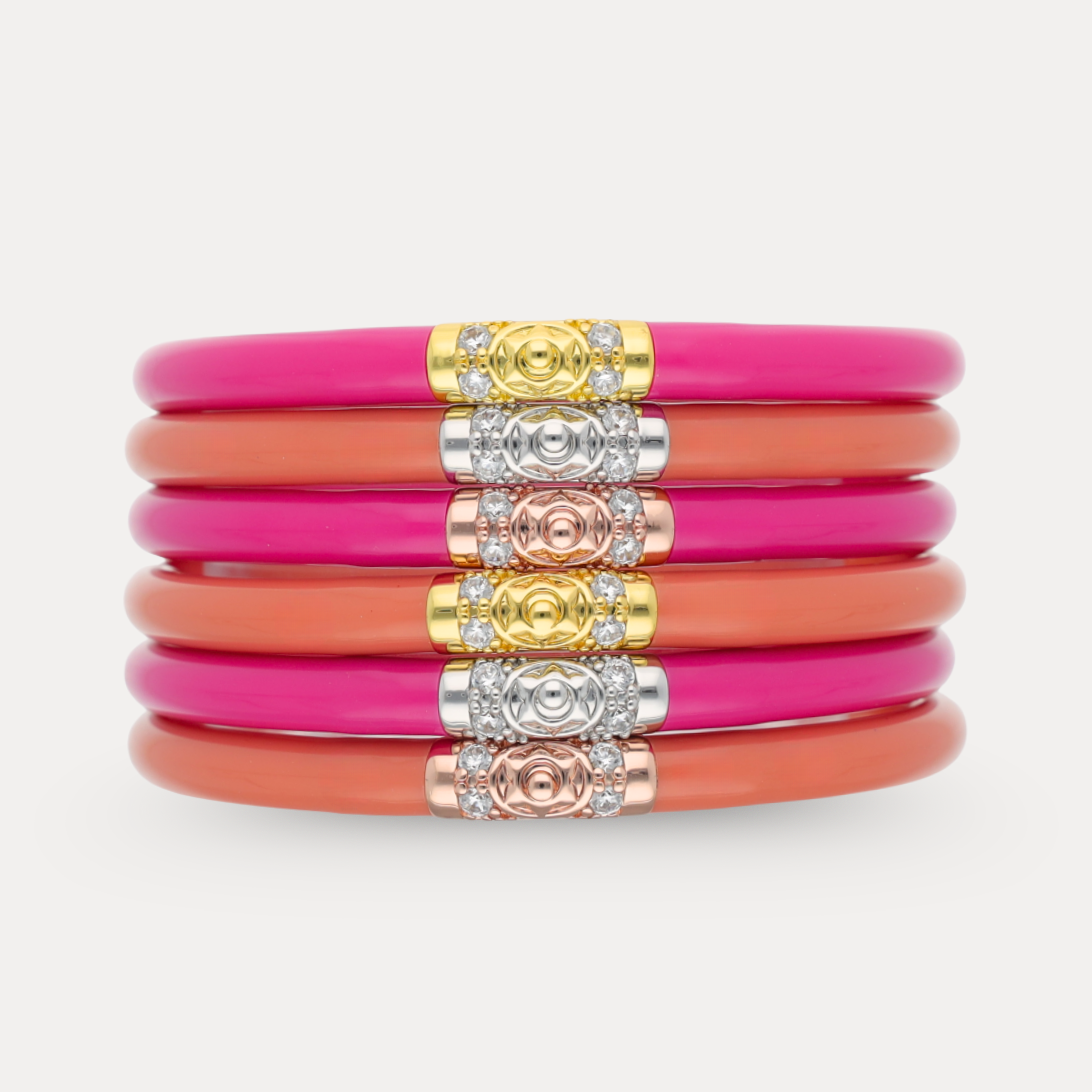 a stack of pink and orange bracelets