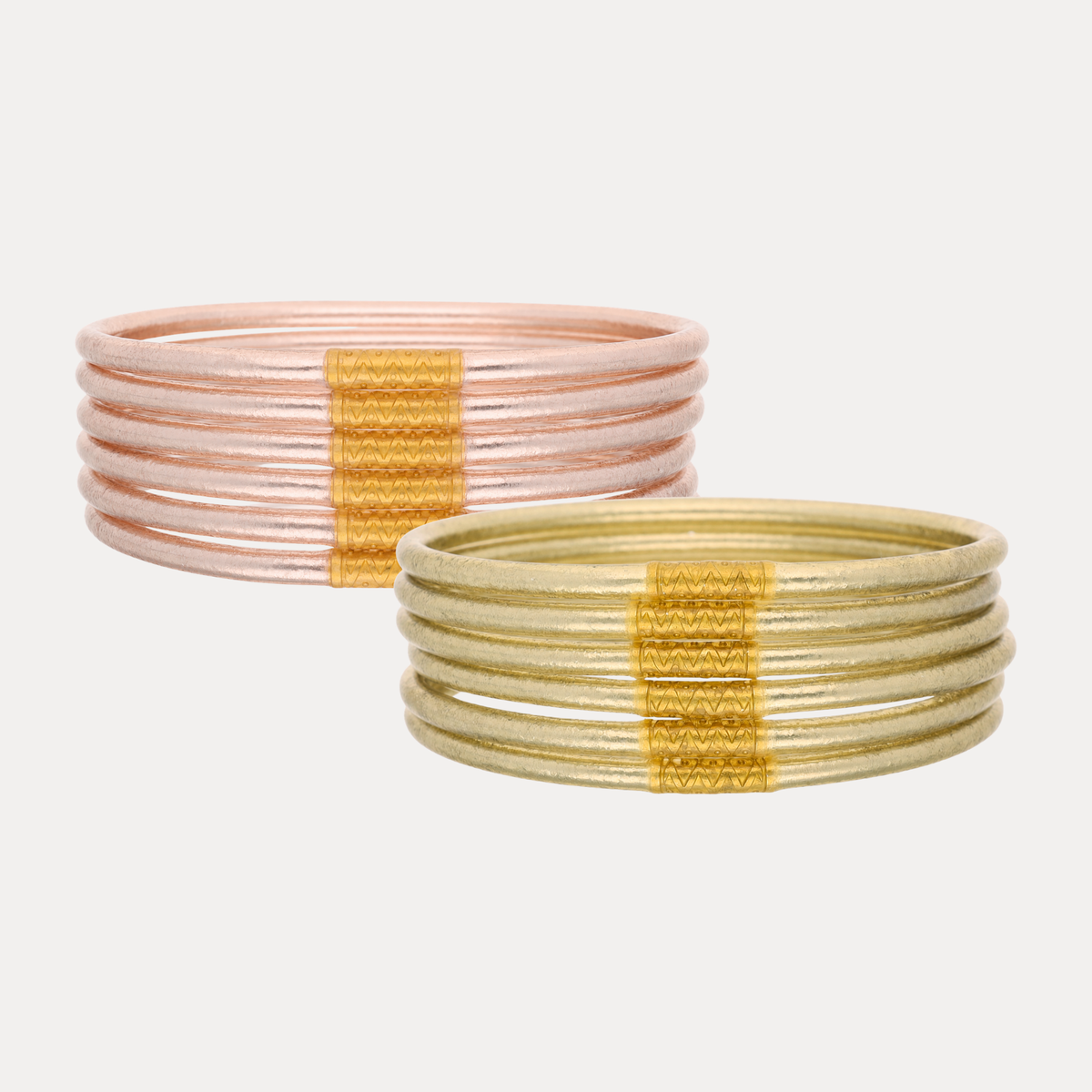 a group of gold and silver bracelets