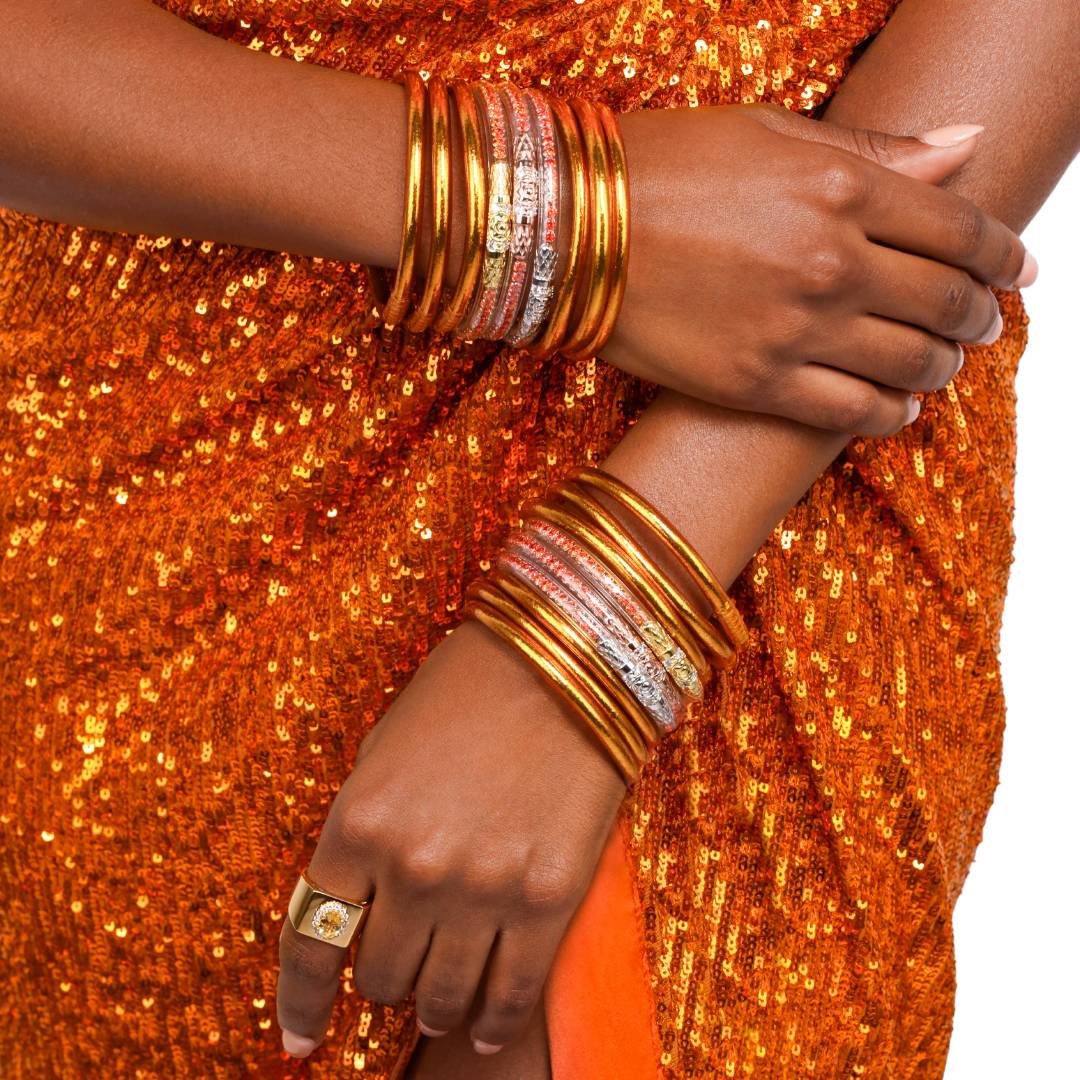 Bright Orange Spark All Weather Bangle Bracelets and Orange Crystal Flame Three Queens All Weather Bangle Bracelets on Model in Orange Sequin Dress | BuDhaGirl