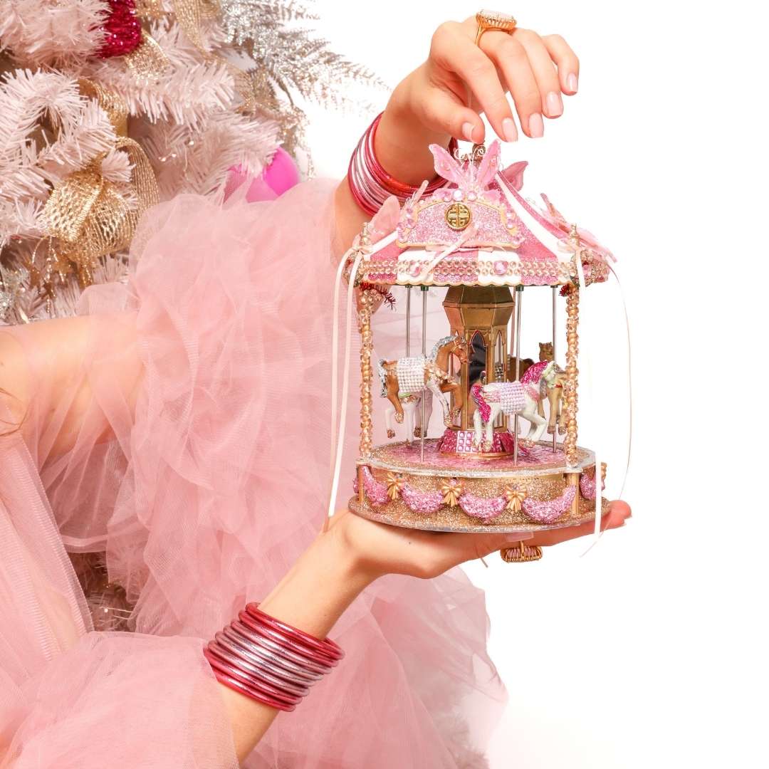 Model wearing Carousel Pink All Weather Bangles while holding Pink Carousel Toy | BuDhaGirl