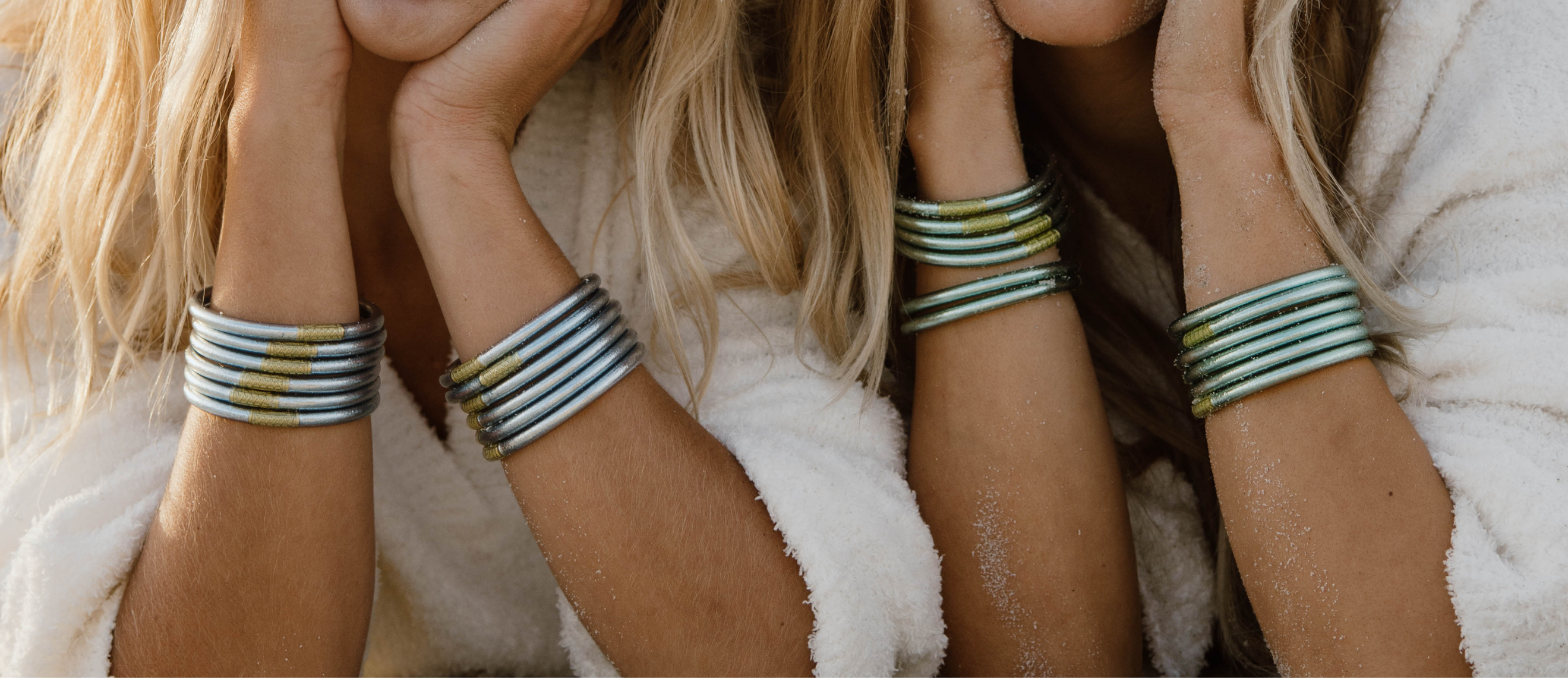 a woman wearing bracelets and white towel