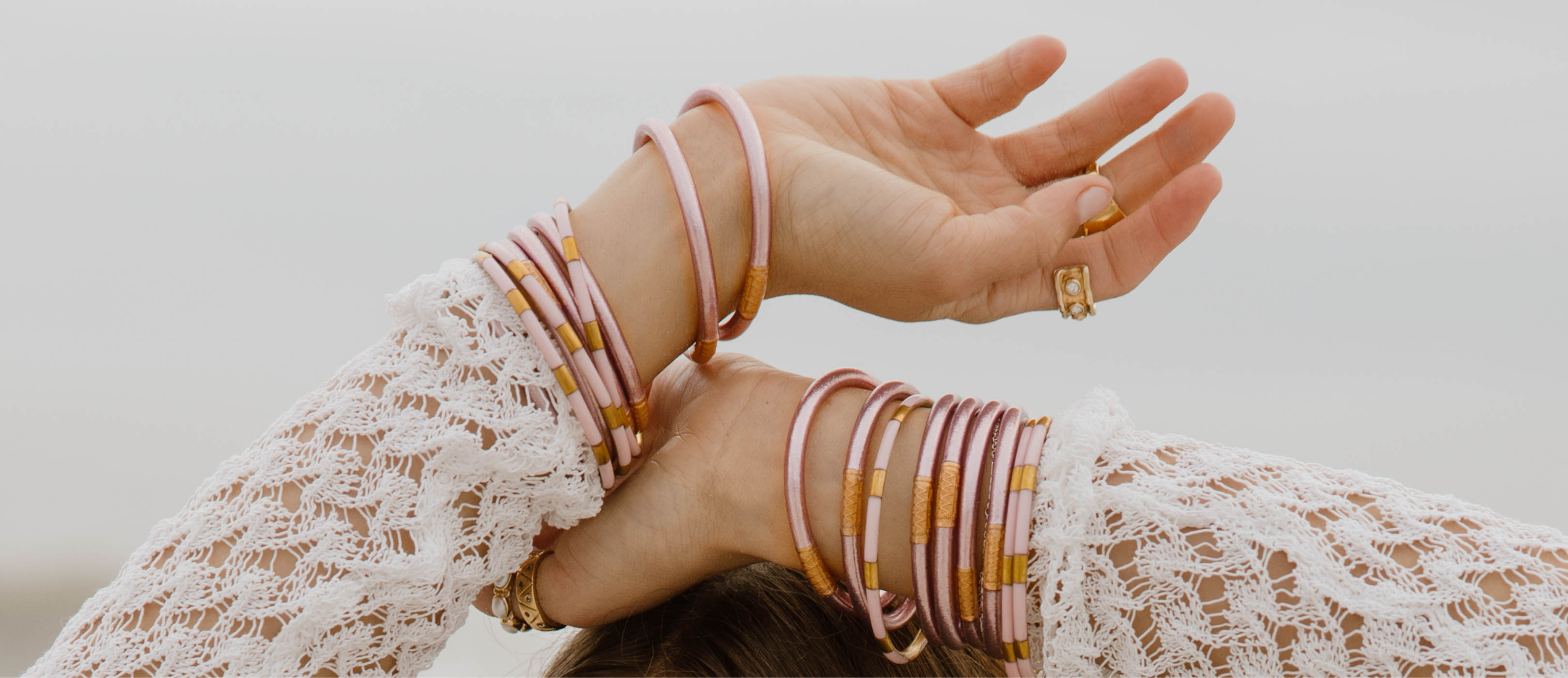 a woman's hands with bracelets
