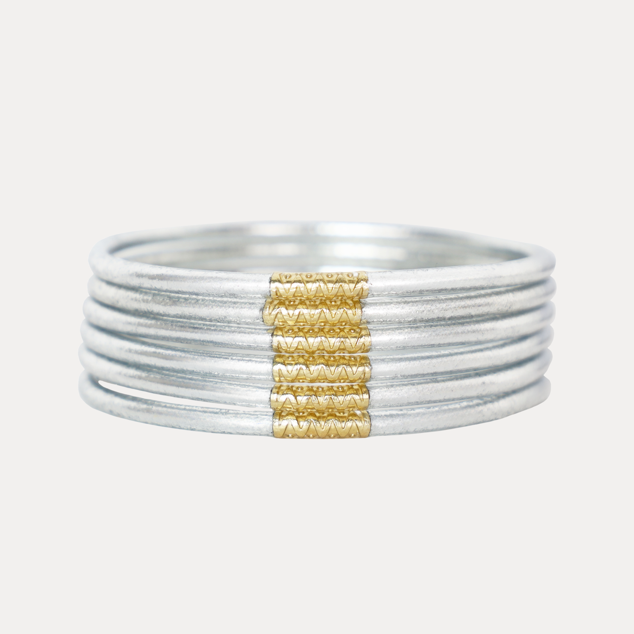 a stack of silver and gold bracelets