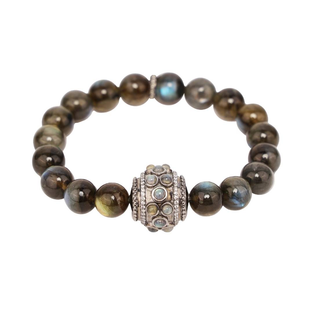 A Labradorite and sterling silver bracelet. The bracelet features a series of polished Labradorite beads, which have a distinctive iridescent sheen. The beads are strung on a delicate sterling silver chain. The bracelet is adjustable to fit most wrist sizes.