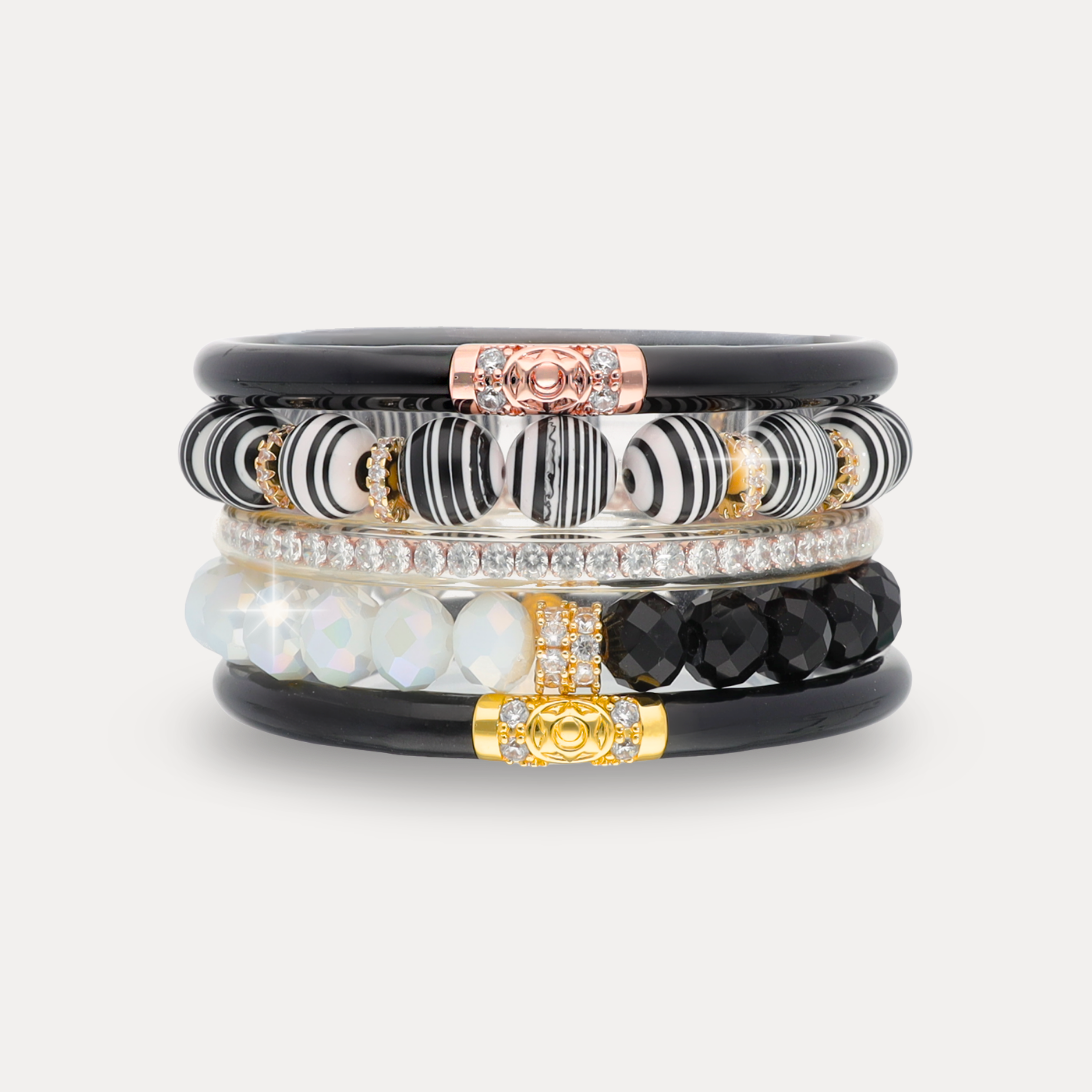a stack of bracelets with black and white beads