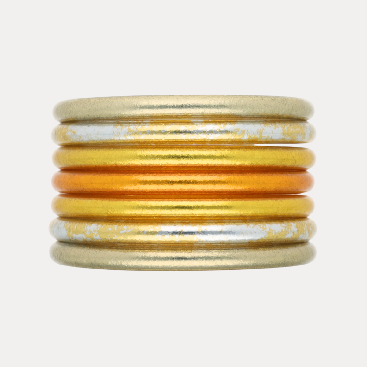Seven stacked gold silver and amber bangle bracelets for women with a soft shimmer and marbled finish by BuDhaGirl inspired by Diwali light