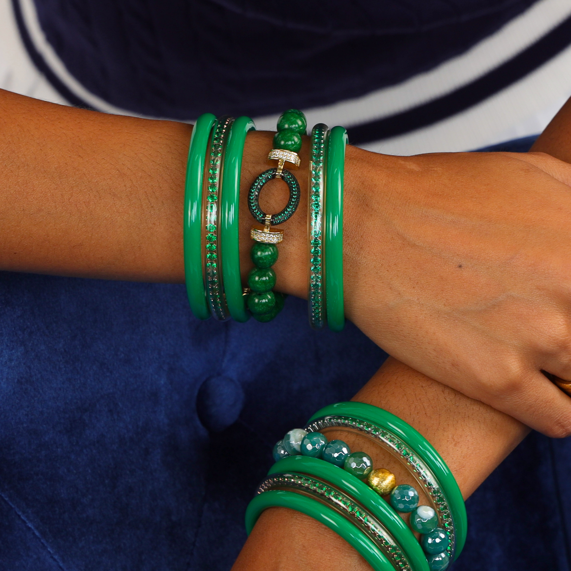 Imperial Bracelet showcased with vibrant green bangle bracelets, accentuated by gold and pavé details.