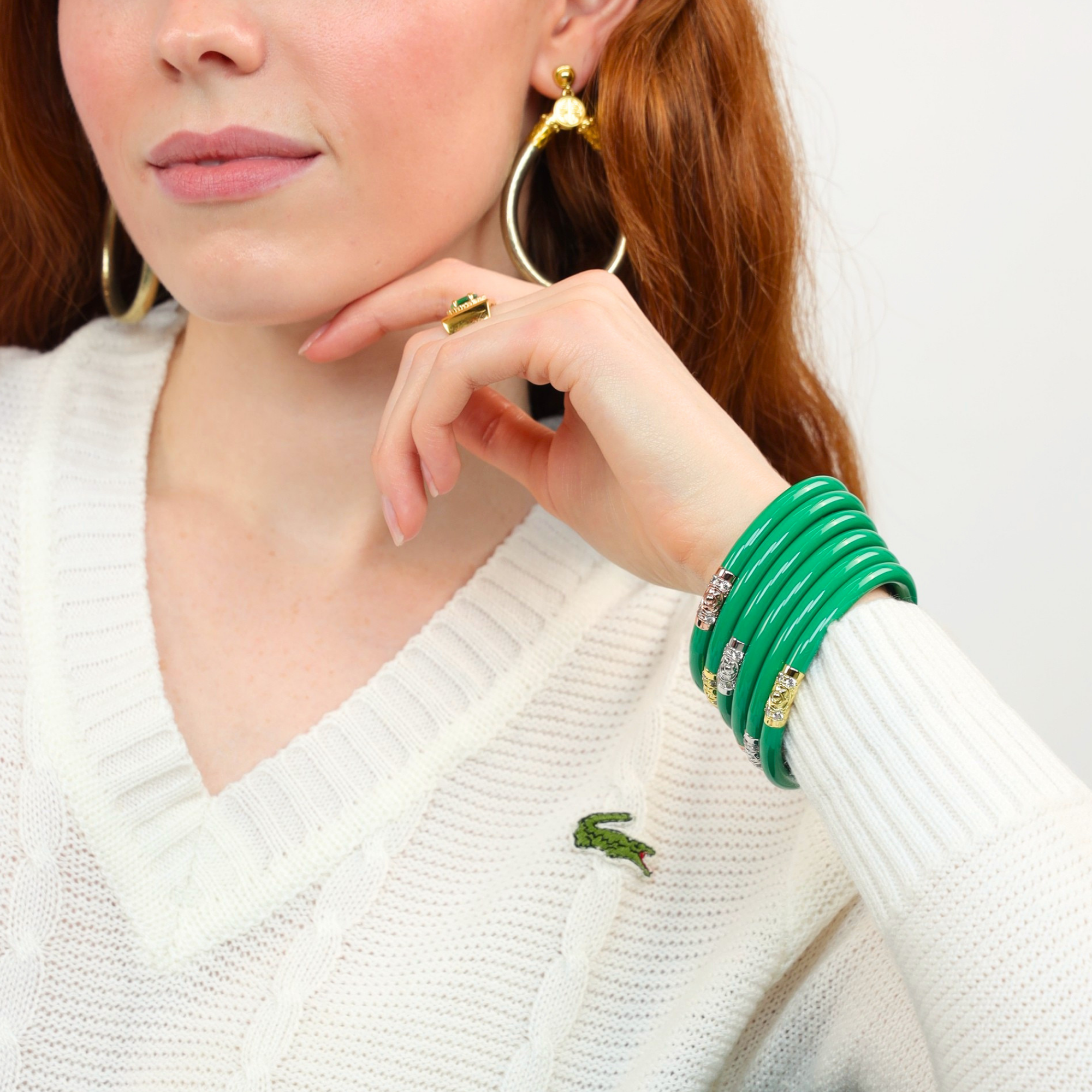 Three Kings All Weather Bangles® (AWB®) - Kelly worn with a cozy white sweater, highlighting country club style.