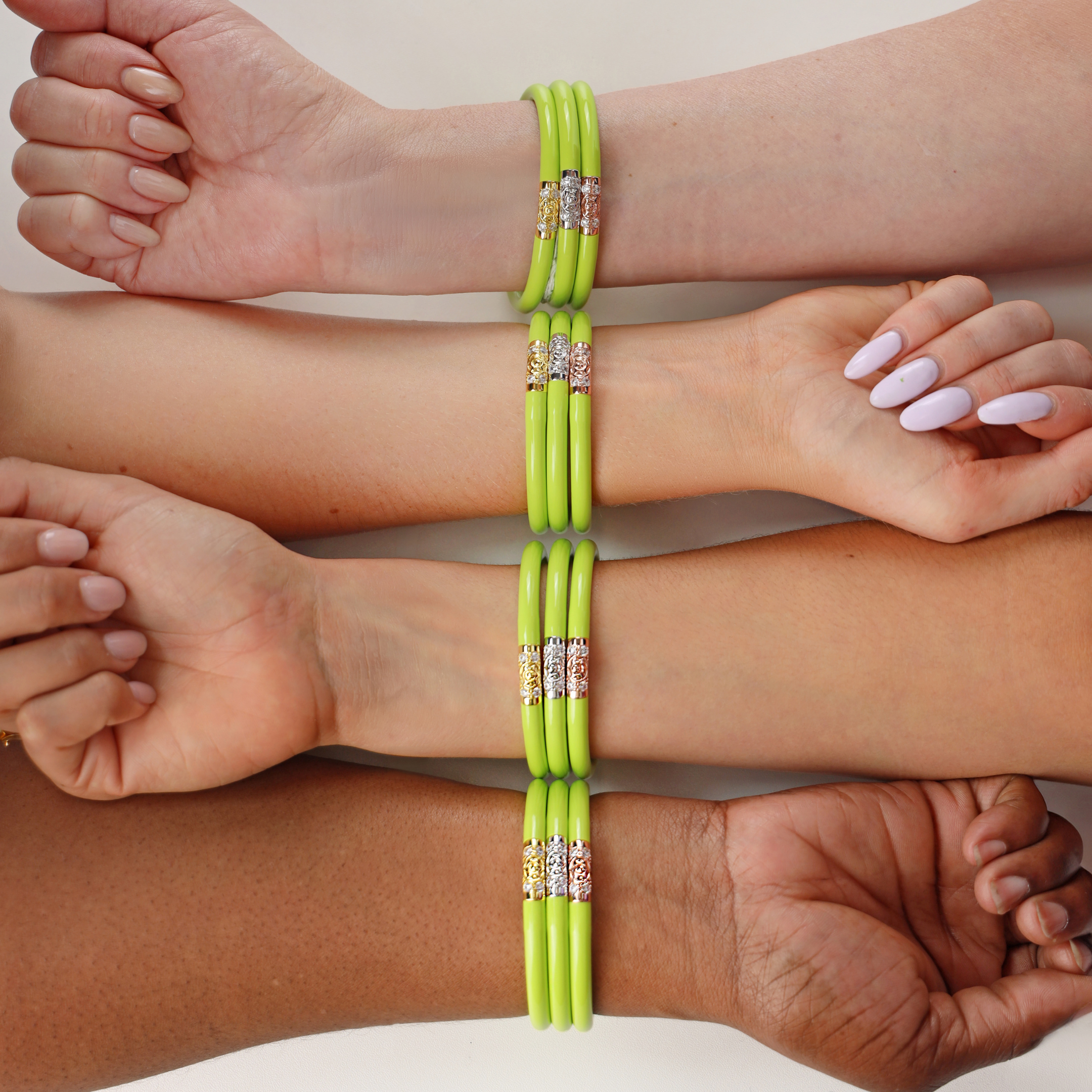 a group of people's hands with bracelets