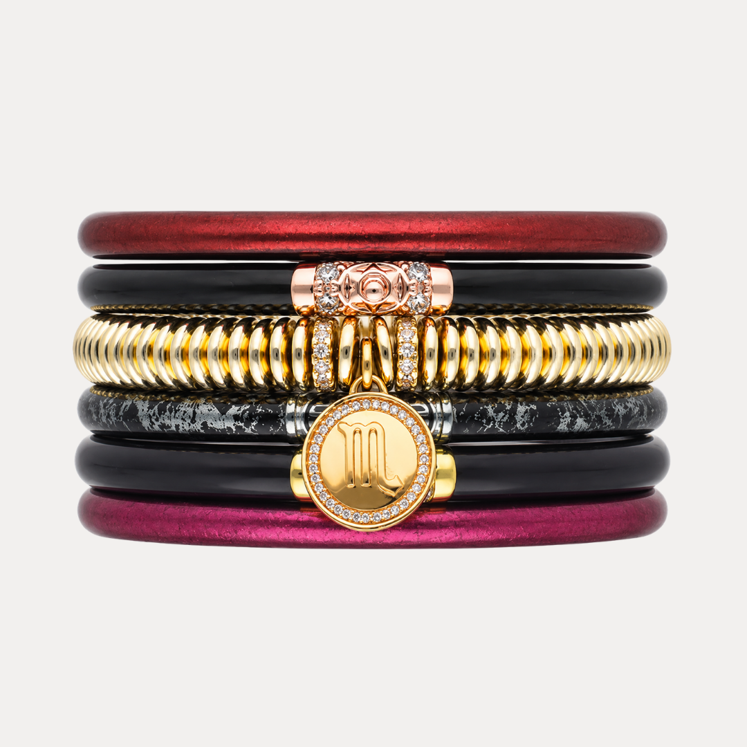 BuDhaGirl Scorpio bangle bracelets for women in red, black, gold, and magenta with a jeweled Scorpio symbol charm centered on the stack